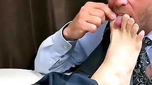Businessman has his feet with the addition of hands sucked severally apart from gay